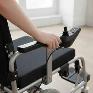 Close-up illustration of a 360-degree joystick controller on the armrest of a lightweight motorized wheelchair.