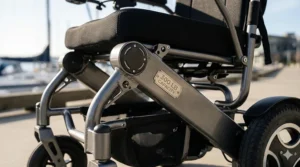 Detailed close-up showing the robust frame and engraved '300 LB CAPACITY' plaque on a durable lightweight electric wheelchair, emphasizing its strength.