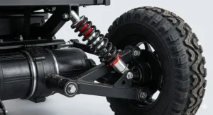A detailed engineering illustration of the heavy-duty power chair suspension system, showing an articulated A-arm and a red coiled shock absorber for smooth outdoor rides.
