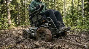 A powerful motorized wheelchair moving steadily through soft mud and wet grass without getting stuck.