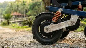Close-up illustration of the rear coil-over suspension system on a power wheelchair for shock absorption.