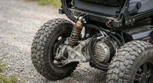 Close-up illustration of the rugged suspension and deep-tread tires on a high ground clearance power wheelchair.