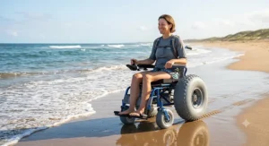 An active individual navigating an all-terrain beach wheelchair smoothly along the wet sand near the shoreline.