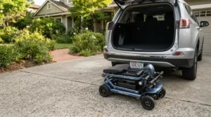 A folding lightweight toddler wheelchair for cerebral palsy placed next to a family car trunk.