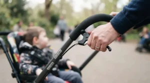 Demonstrating attendant hand brakes during a pediatric transport chair vs self-propelled kids wheelchair evaluation